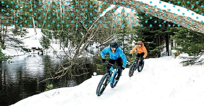 two e-bike riders riding in snow