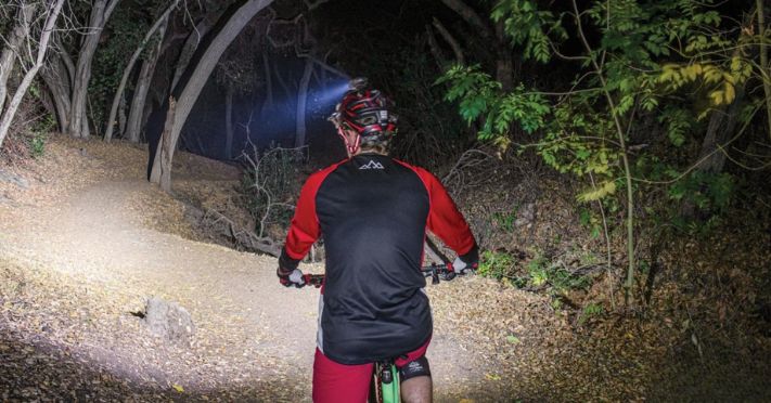 Man lighting the trail with his helmet light