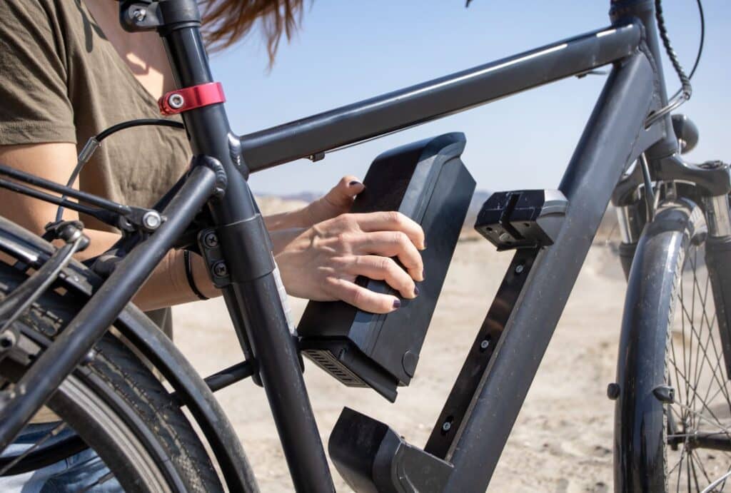 woman placing e-bike battery